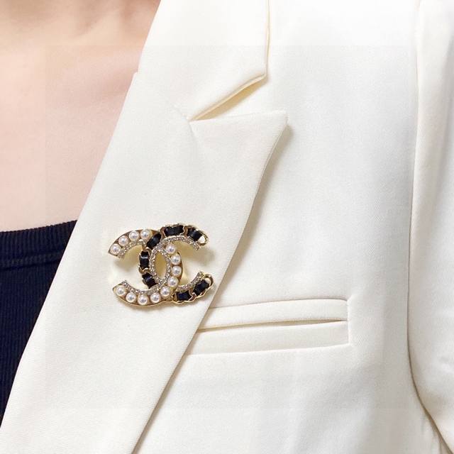 Chanel小香 专柜新款皮革加珍珠镶钻香奈儿胸针，是最懂女人的饰物。那些倾注了全部心血去做自己的女人，往往更珍惜胸针的意义。香奈儿女士把胸针别在帽子上，并告诉